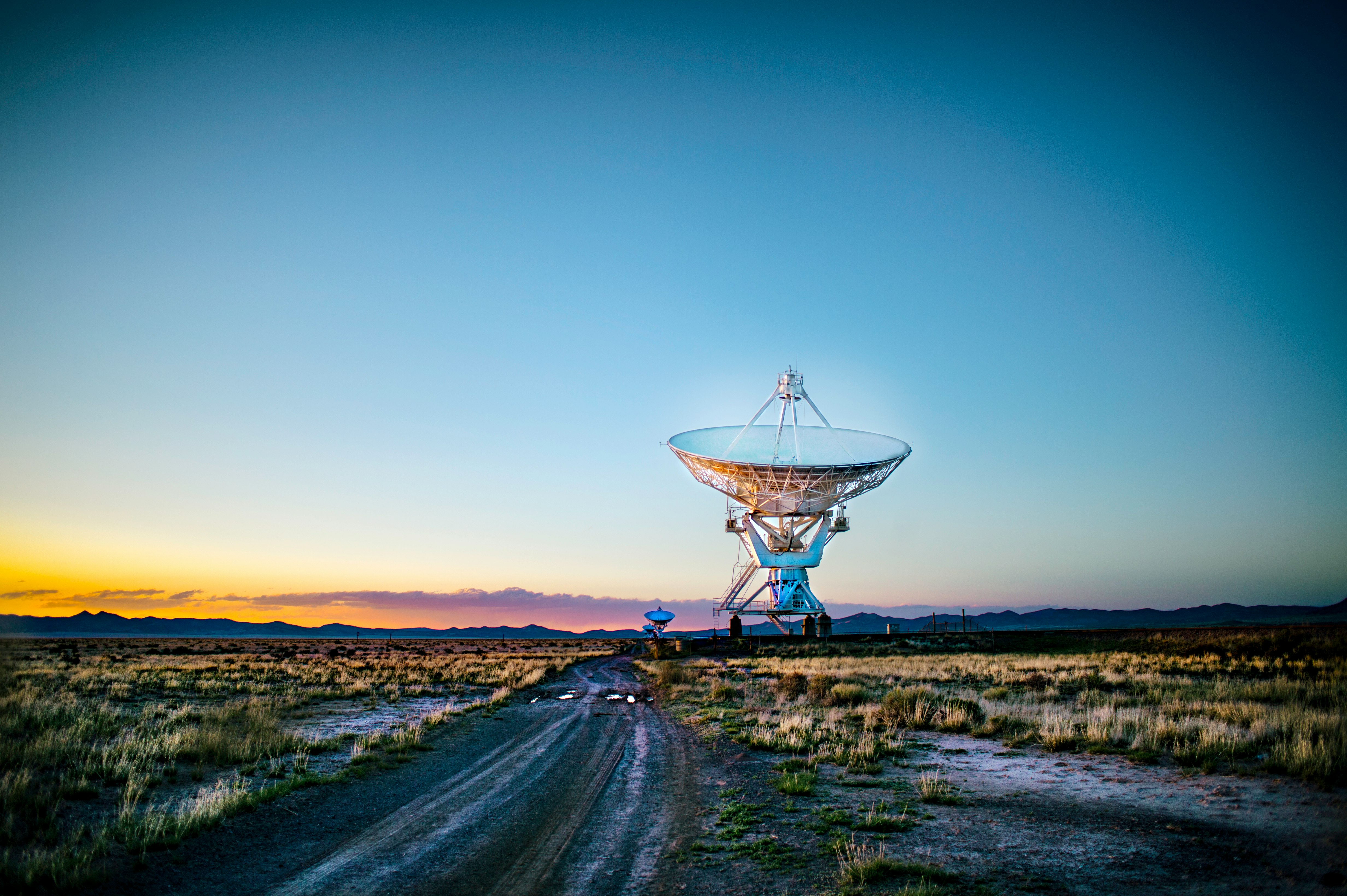 white radar telescope on grass field